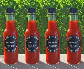 four bottles red jalapeno hot sauce
